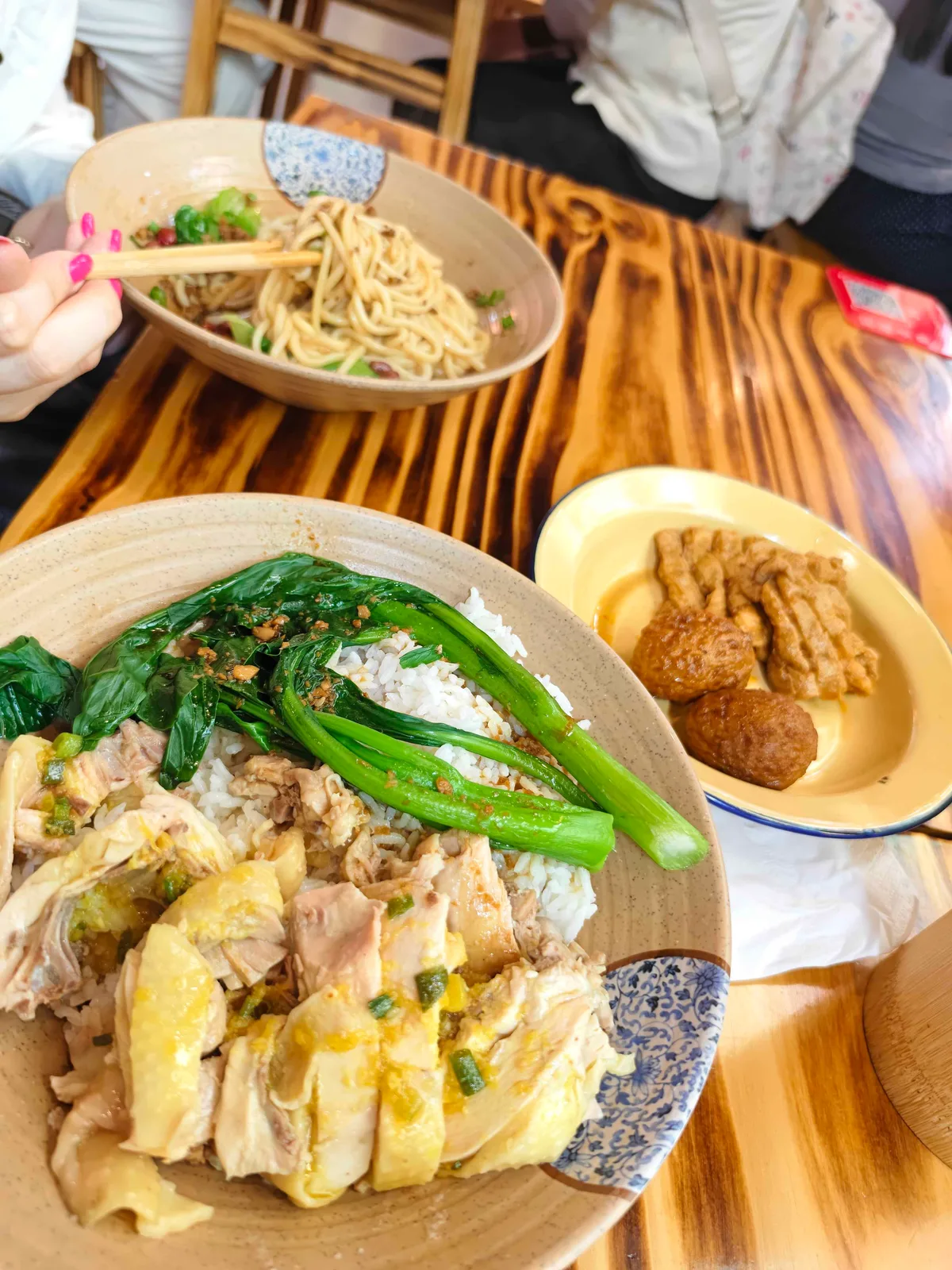 A shared table of chicken rice, noodles and fried tofu skin in Shenzhen