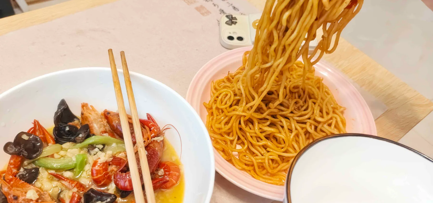 A bowl of crayfish and a lift of noodles on a Shenzhen table