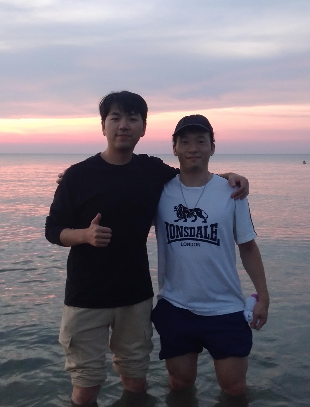 Bryan and Takahiro by the water at sunset
